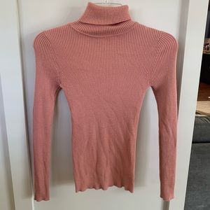 Women’s tight fitting pink turtleneck sweater top